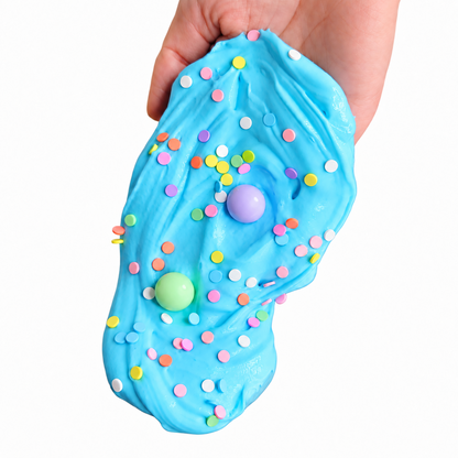 Blue Bubblegum Paleta slime stretched vertically with sprinkles and two beads