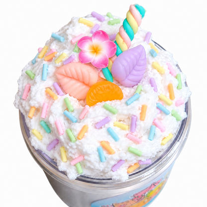 Open Piña Colada snow fizz slime jar topped with five charms and pastel sprinkles