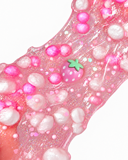 Stretched sparkly pink Strawberry Sparkling Soda slime with strawberry charm and foam beads
